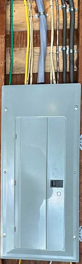 Residential electrical panel with wires above.